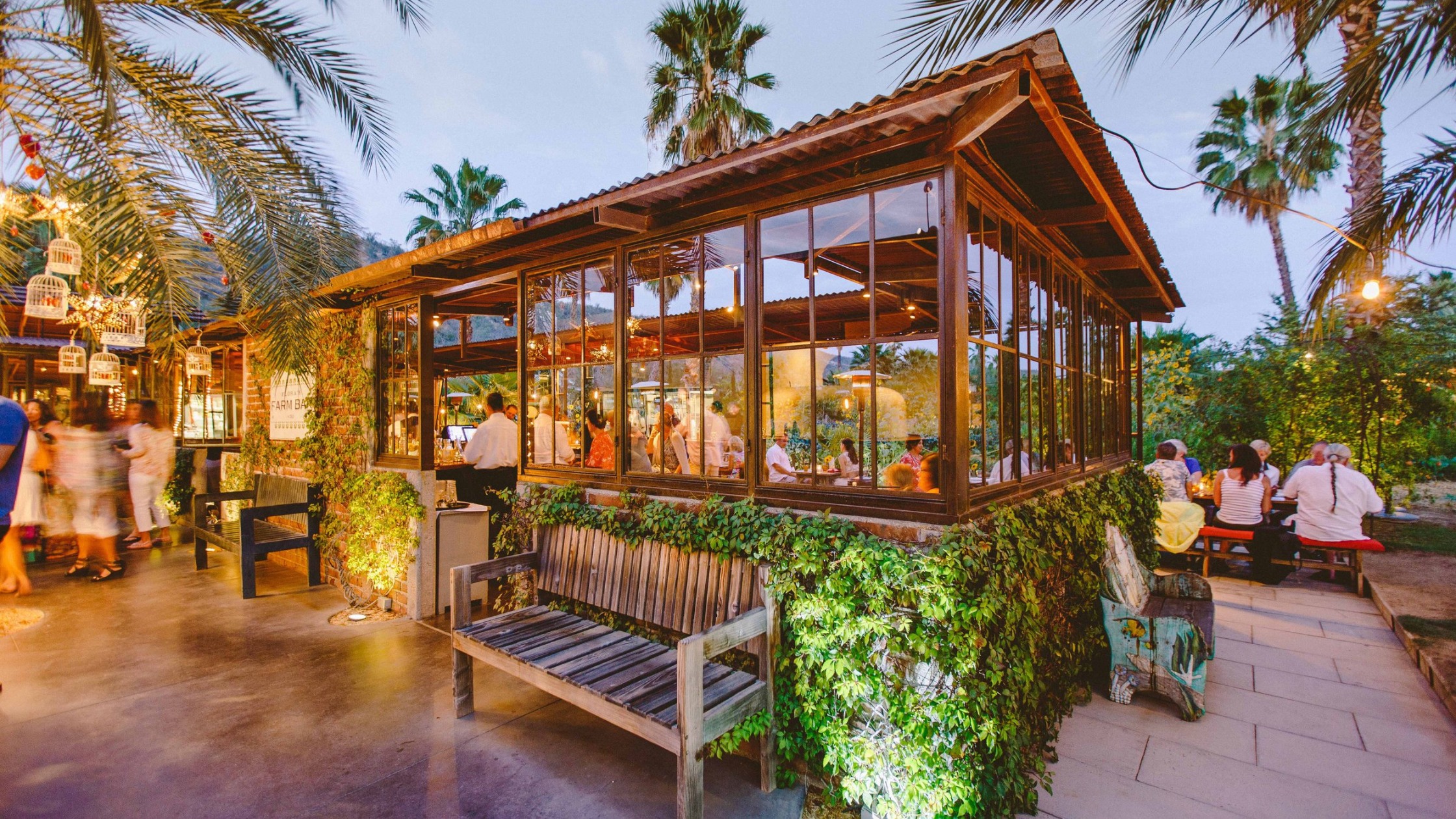 Farm-to-table dining at Flora Farms with organic gardens and outdoor seating under trees
